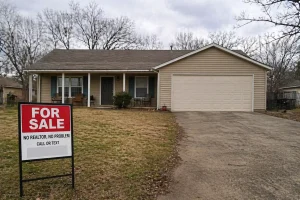 Bixby Oklahoma suburban home with for sale sign sitting on market longer due to slower home sales conditions
