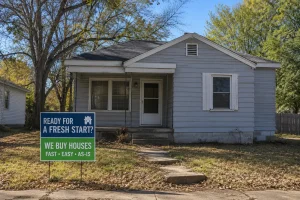 Older home in Sand Springs Oklahoma with cash home buyer sign offering a stress free as-is home sale